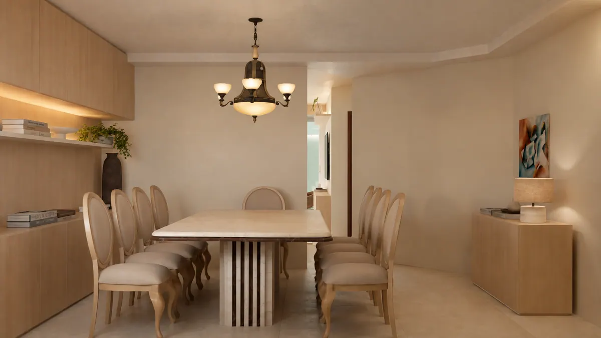 Sala de jantar vista de lado: mesa longa de tampo claro, cadeiras medalhão e marcenaria com nicho iluminado